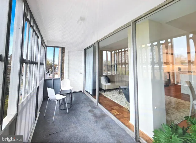 a living room with furniture and a floor to ceiling window