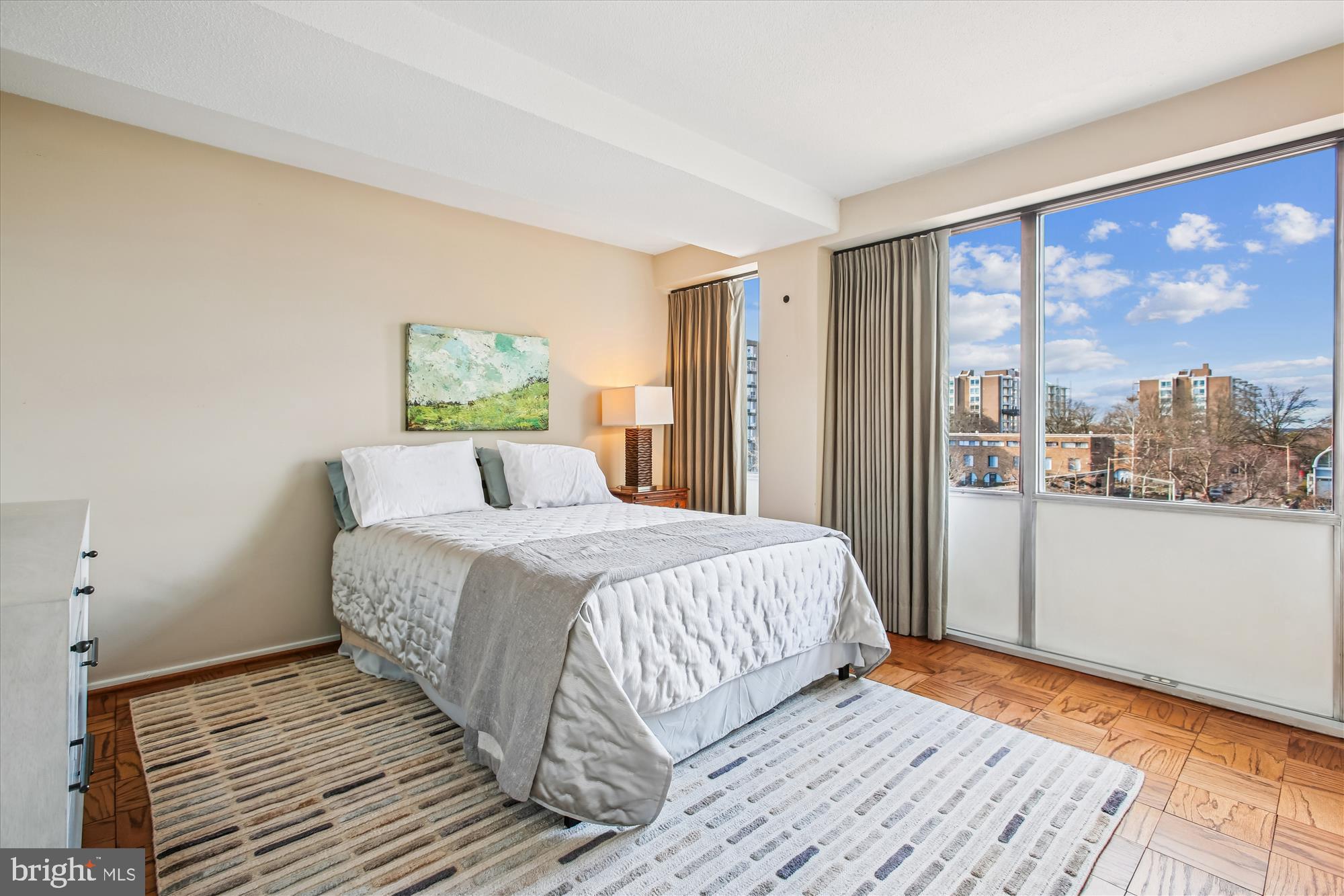 1311 Delaware Avenue Southwest, Unit S331 Washington, DC 20024 - Photo 14 of 35 a bedroom with a large bed and a large window