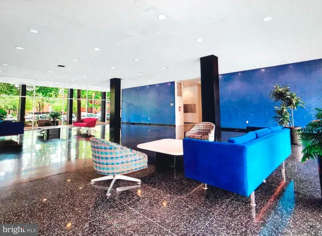 a living room with furniture and floor to ceiling window