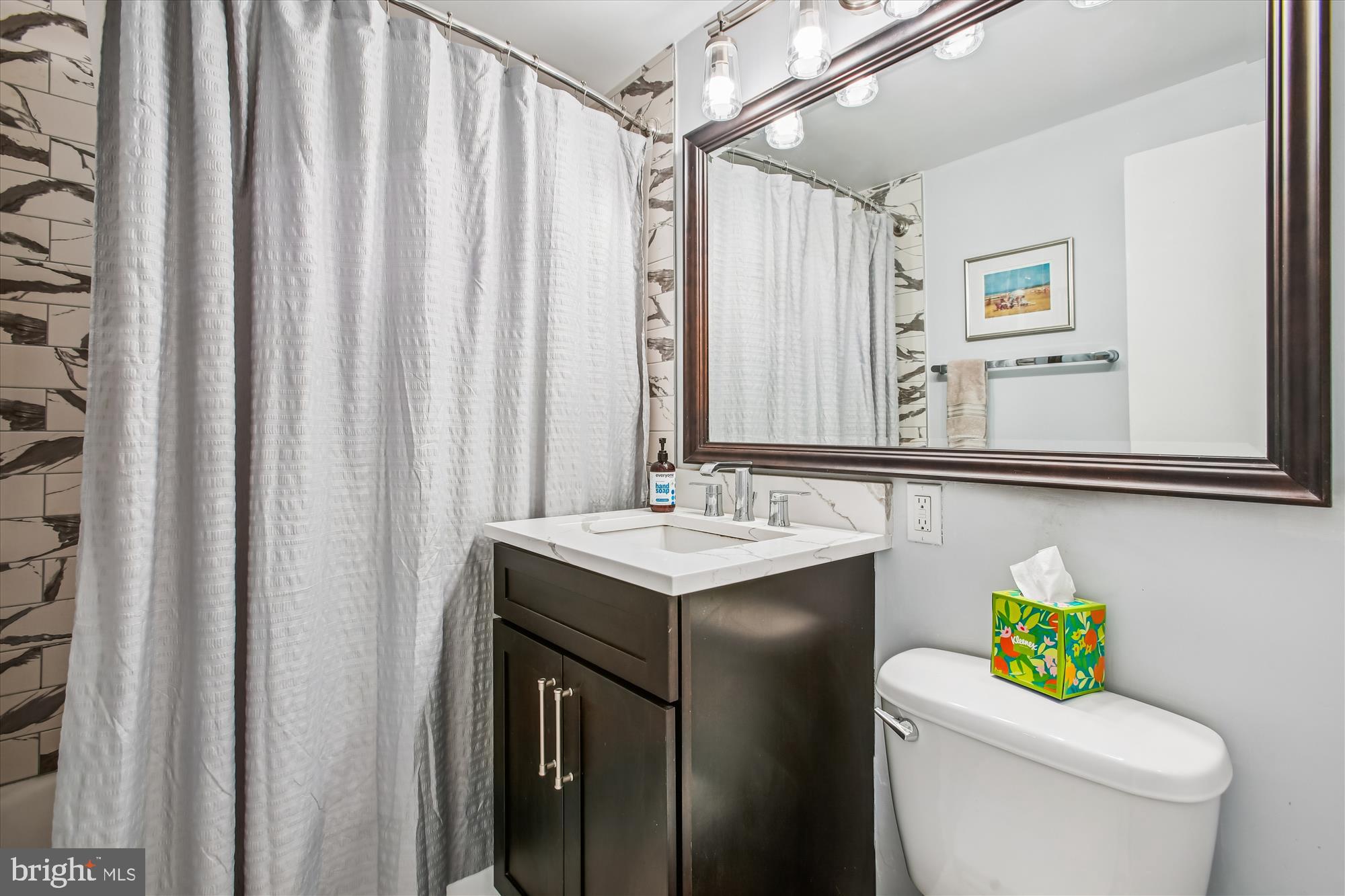 1311 Delaware Avenue Southwest, Unit S331 Washington, DC 20024 - Photo 18 of 35 a bathroom with a sink mirror vanity and toilet