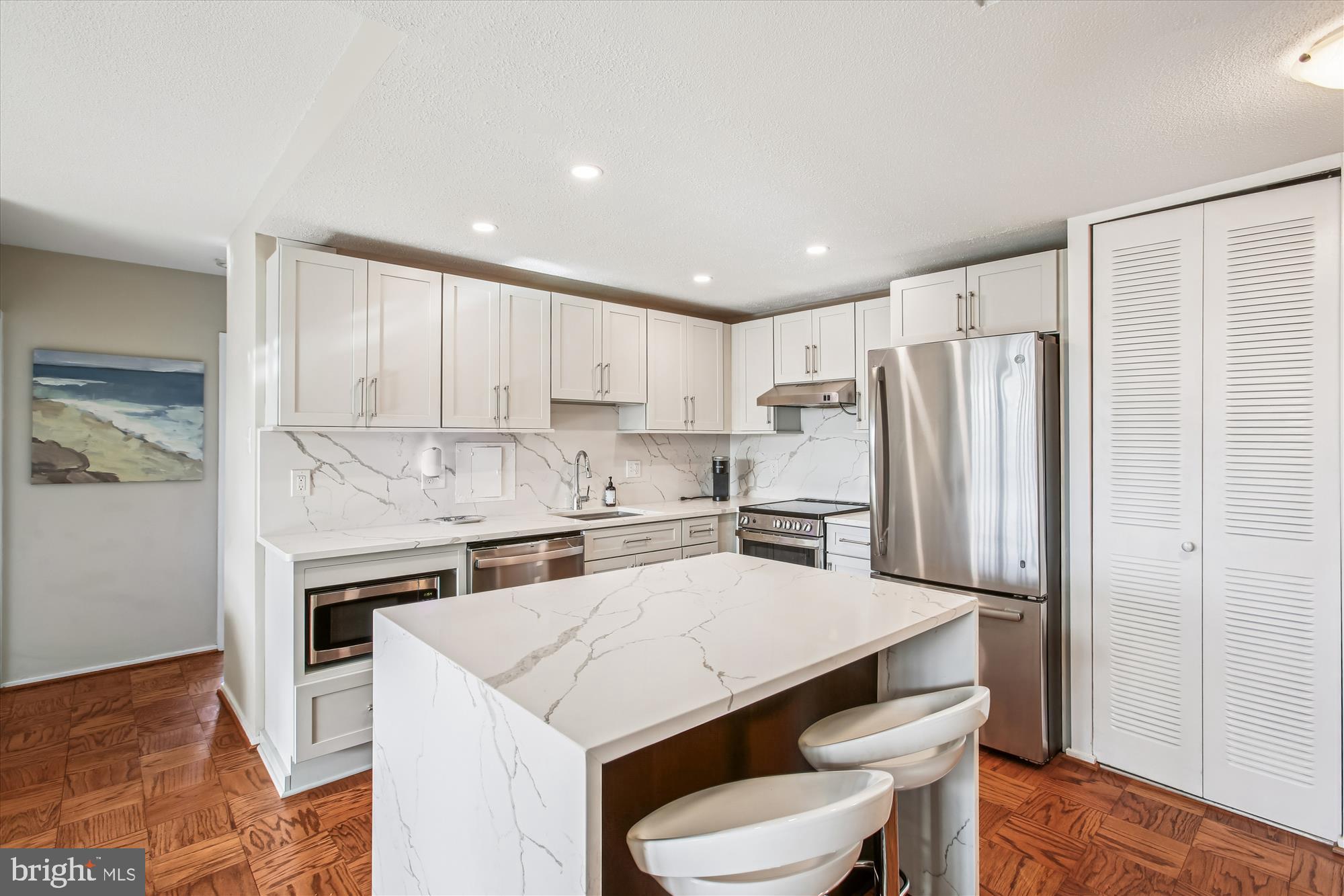 1311 Delaware Avenue Southwest, Unit S331 Washington, DC 20024 - Photo 3 of 35 a kitchen with a sink a stove a refrigerator and white cabinets