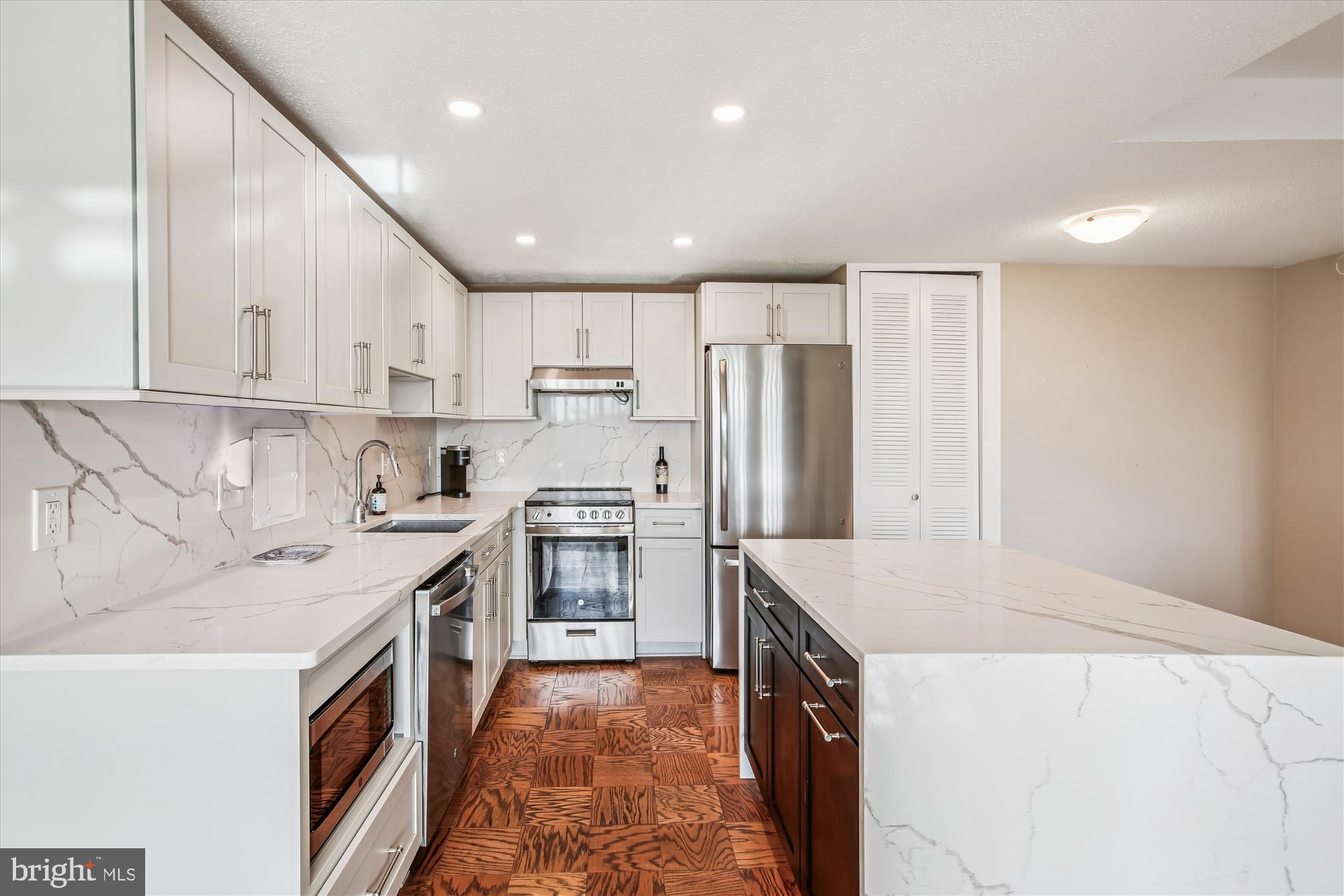 1311 Delaware Avenue Southwest, Unit S331 Washington, DC 20024 - Photo 6 of 35 a kitchen with a sink a stove a refrigerator a oven and white cabinets