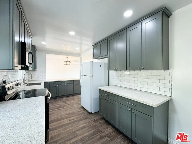 a kitchen with a sink appliances and cabinets