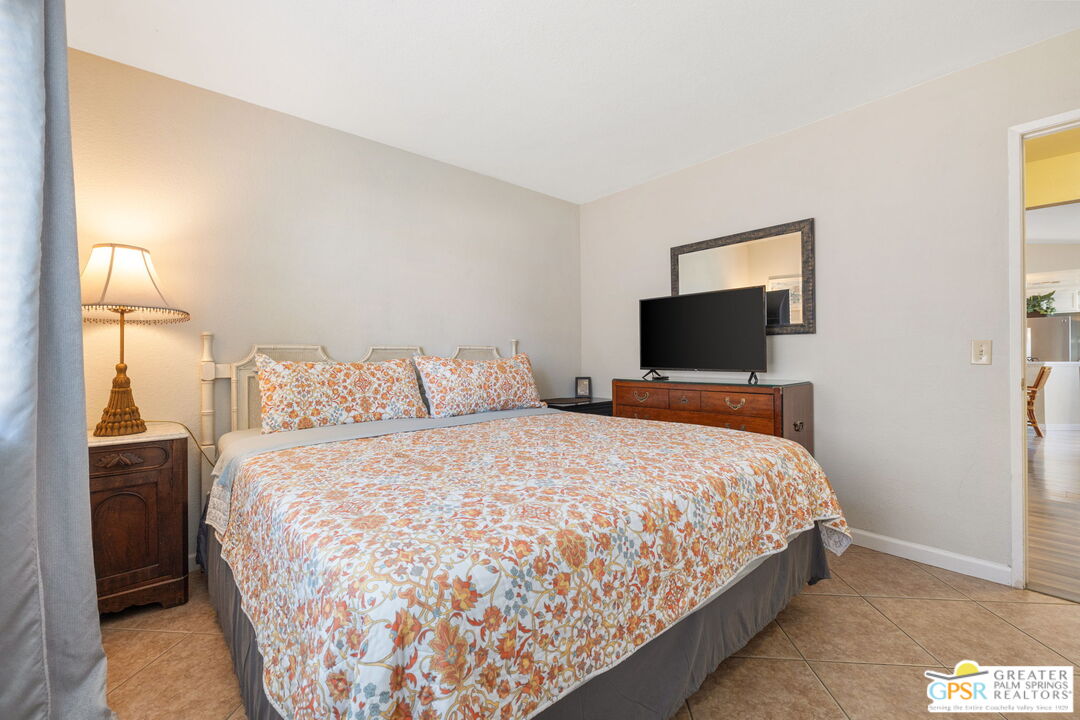 45688 Sutter Creek Road Indio, CA 92201 - Photo 33 of 51 a bedroom with a bed and a flat screen tv