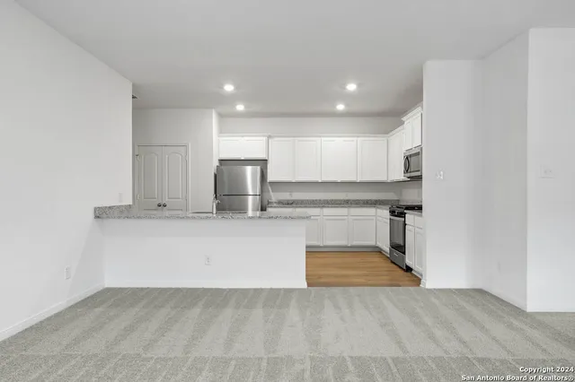 a view of a kitchen with a sink and a kitchen view