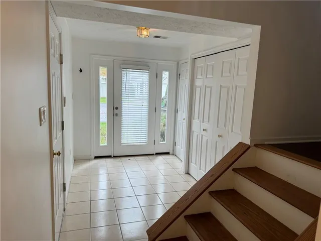 a view of a hallway with wooden floor and closet area