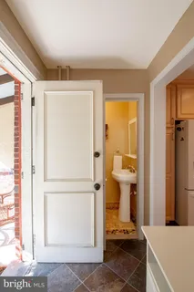 a view of a hallway with bathroom and a shower