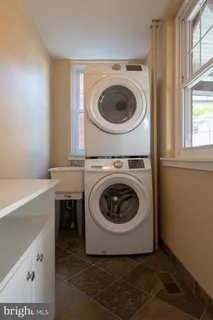 a utility room with sink dryer and washer