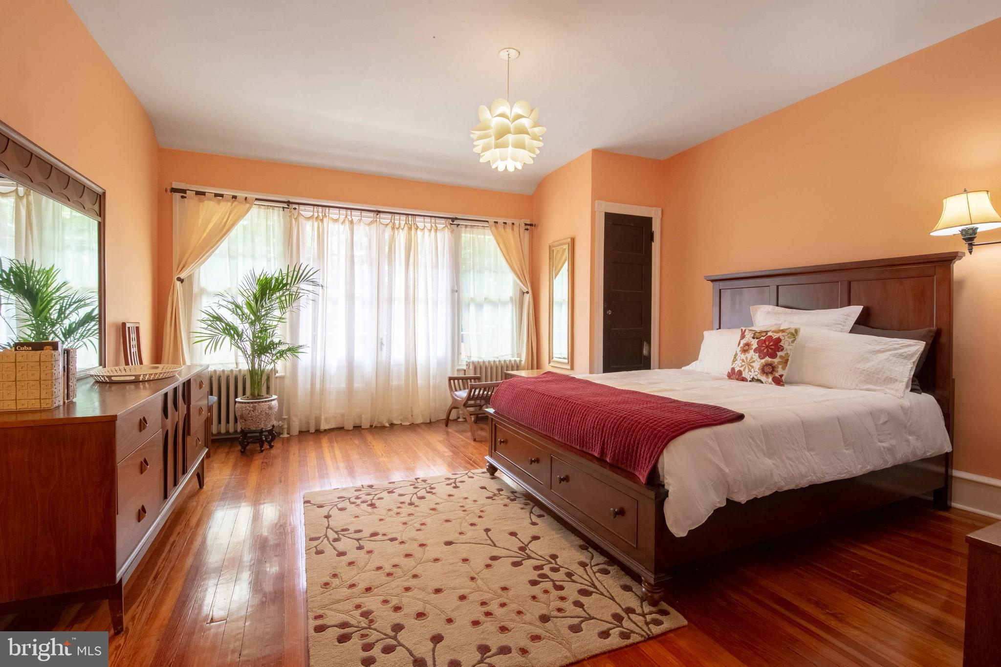 2526 South Cleveland Street Philadelphia, PA 19145 - Photo 19 of 29 a spacious bedroom with a large bed and a chandelier