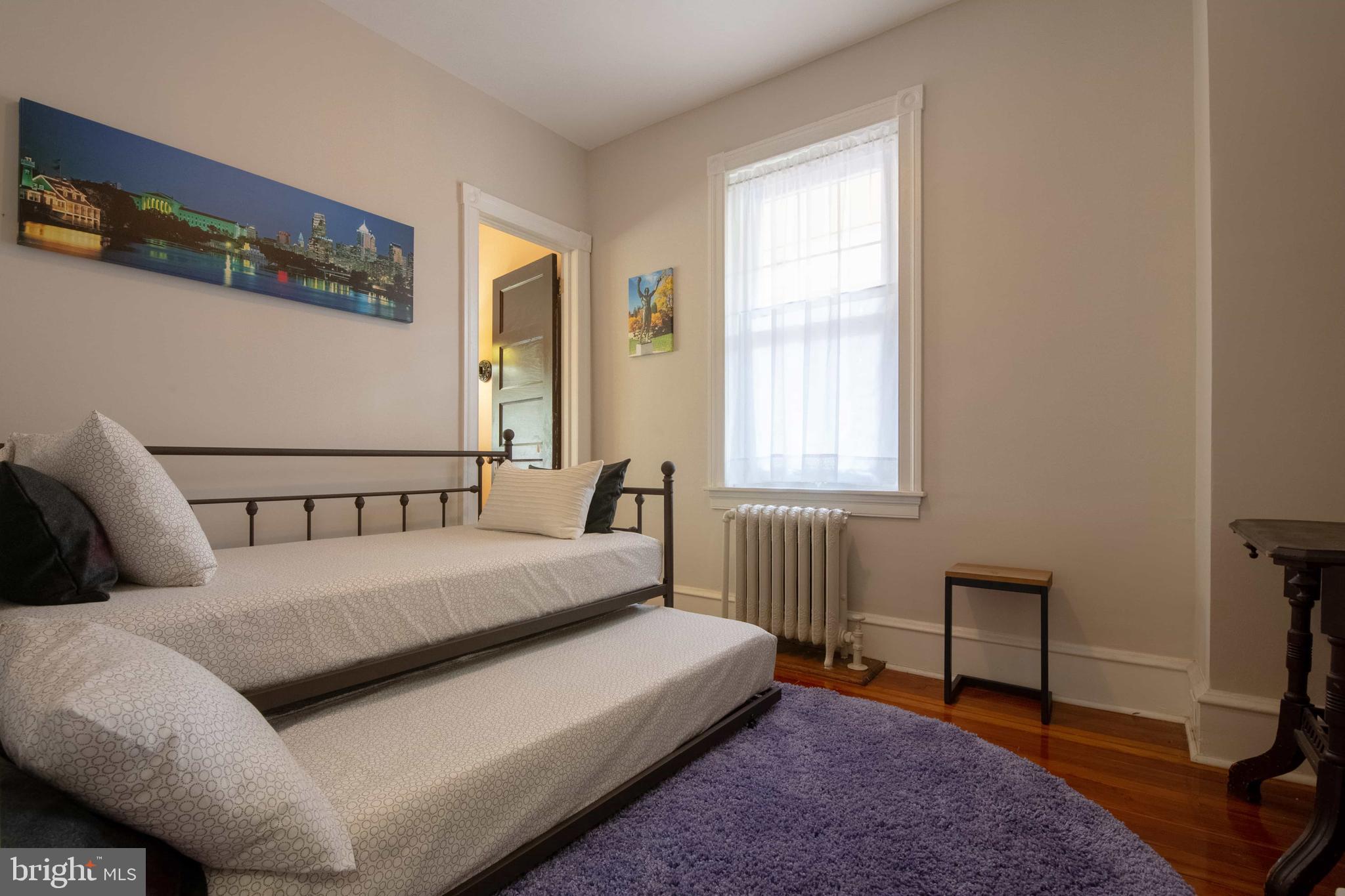 2526 South Cleveland Street Philadelphia, PA 19145 - Photo 23 of 29 a bed sitting in a bedroom next to a window