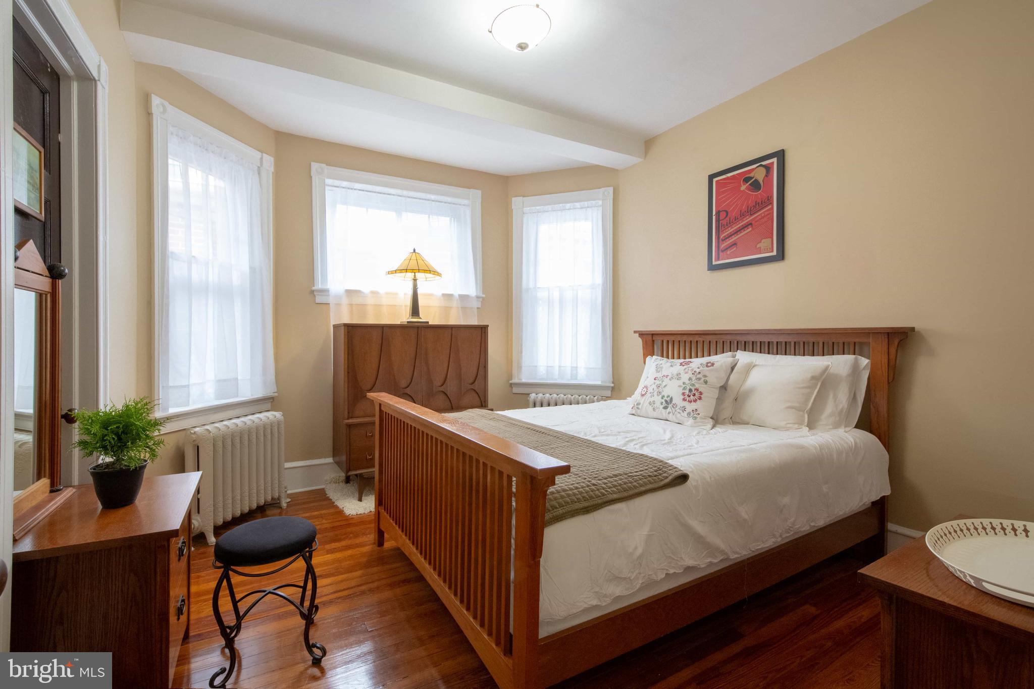 2526 South Cleveland Street Philadelphia, PA 19145 - Photo 24 of 29 a bedroom with a bed and a potted plant