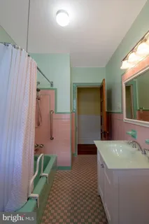 a bathroom with a bathtub and shower