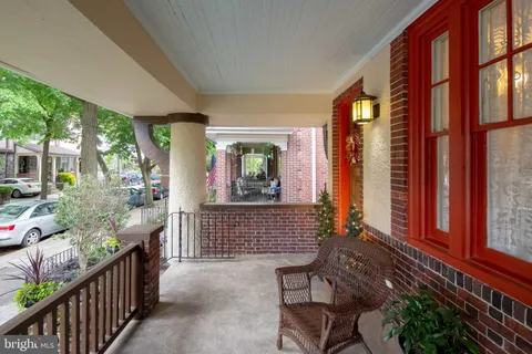 a view of house with two chairs and potted plants