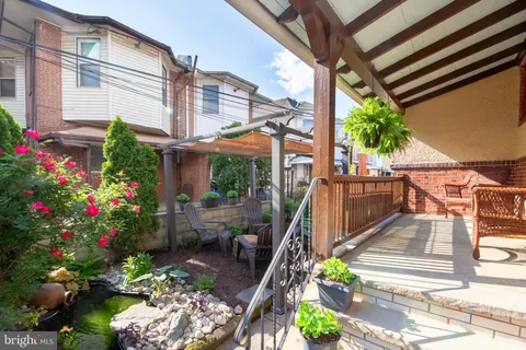 a view of a chairs and table in the backyard