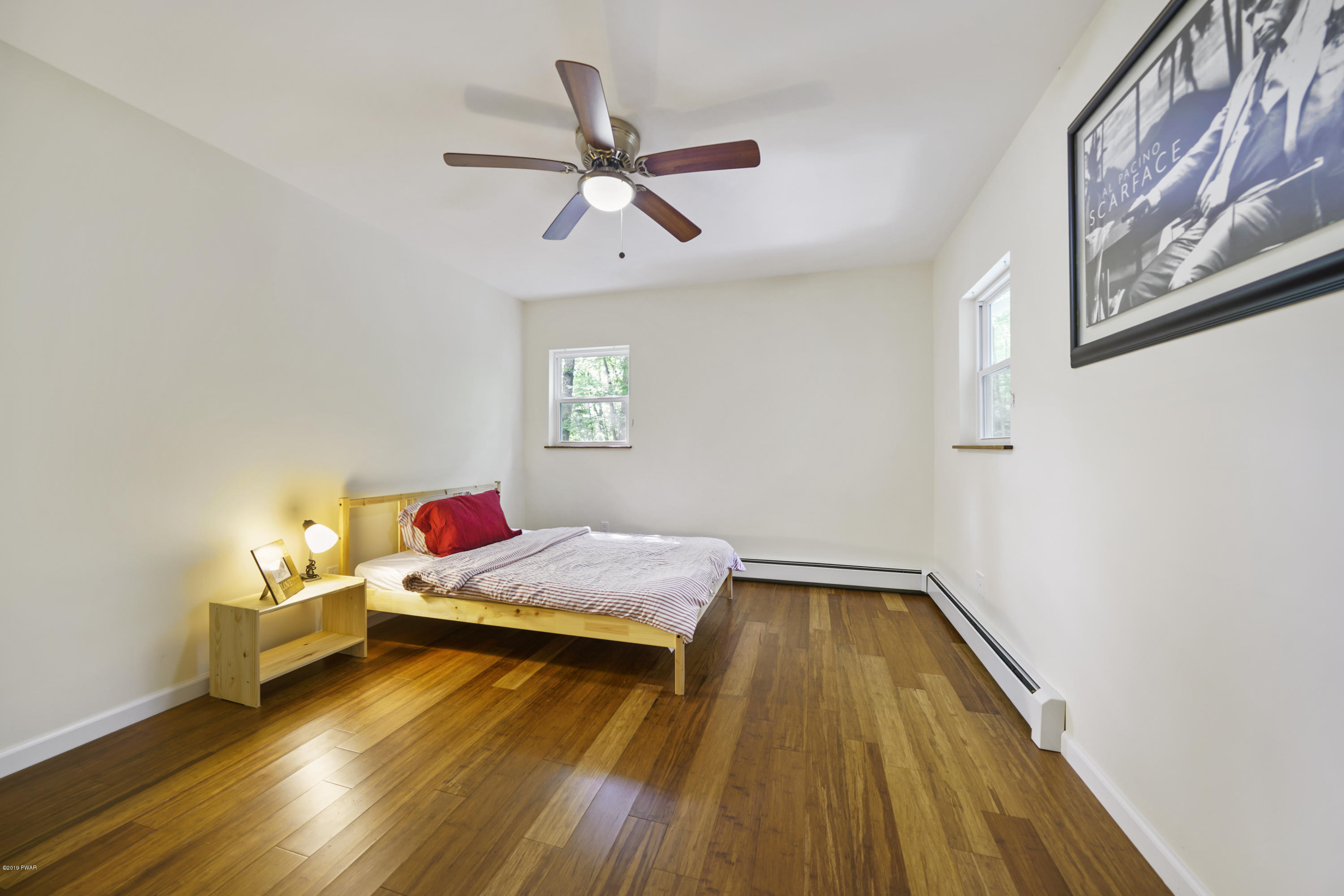 176 Gold Key Road Milford, PA 18337 - Photo 18 of 27 a bedroom with a bed and wooden floor