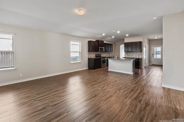 a view of kitchen dining table wooden floor and kitchen view