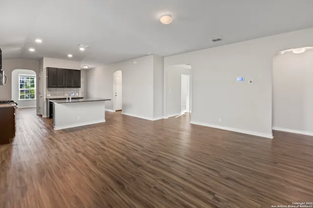 a view of kitchen with microwave and refrigerator