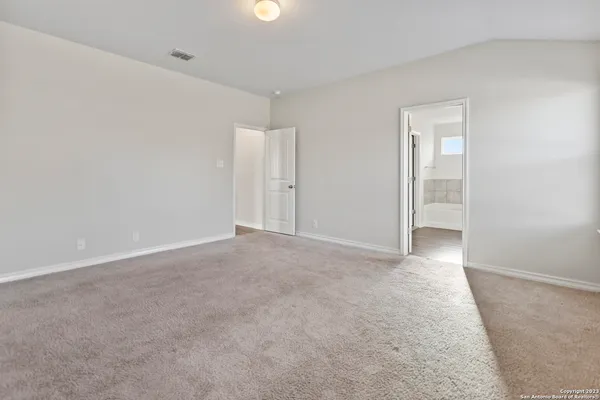 a bathroom with a tub sink shower and two mirror