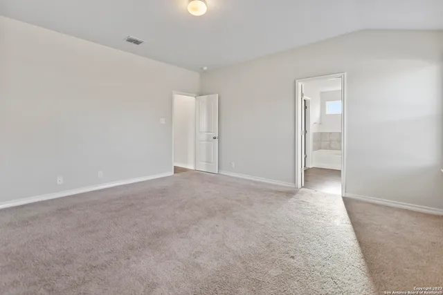 a bathroom with a tub sink shower and two mirror