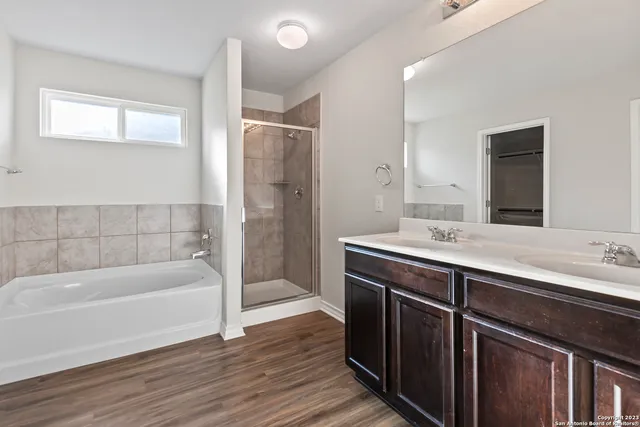 a white bath tub sitting next to a shower