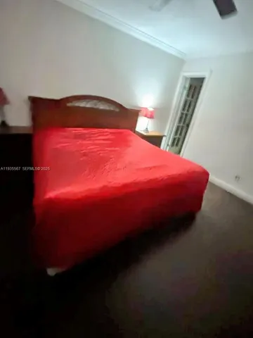 a large bed sitting in a bedroom next to a larger window