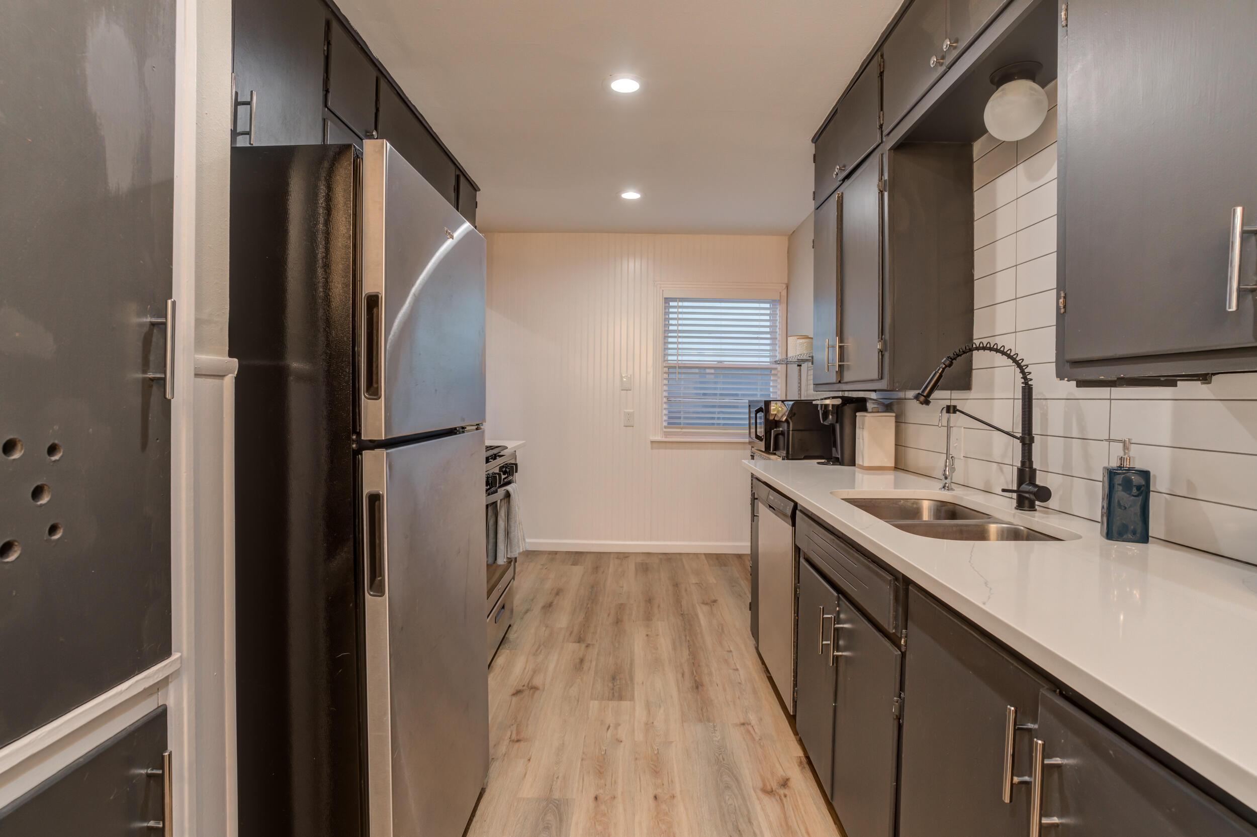 2802 39th Street Lubbock, TX 79413 - Photo 18 of 61 a kitchen with stainless steel appliances granite countertop refrigerator sink and cabinets