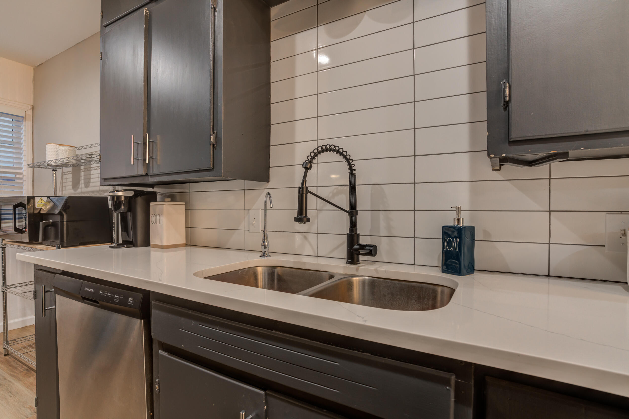 2802 39th Street Lubbock, TX 79413 - Photo 21 of 61 a kitchen with a sink and cabinets