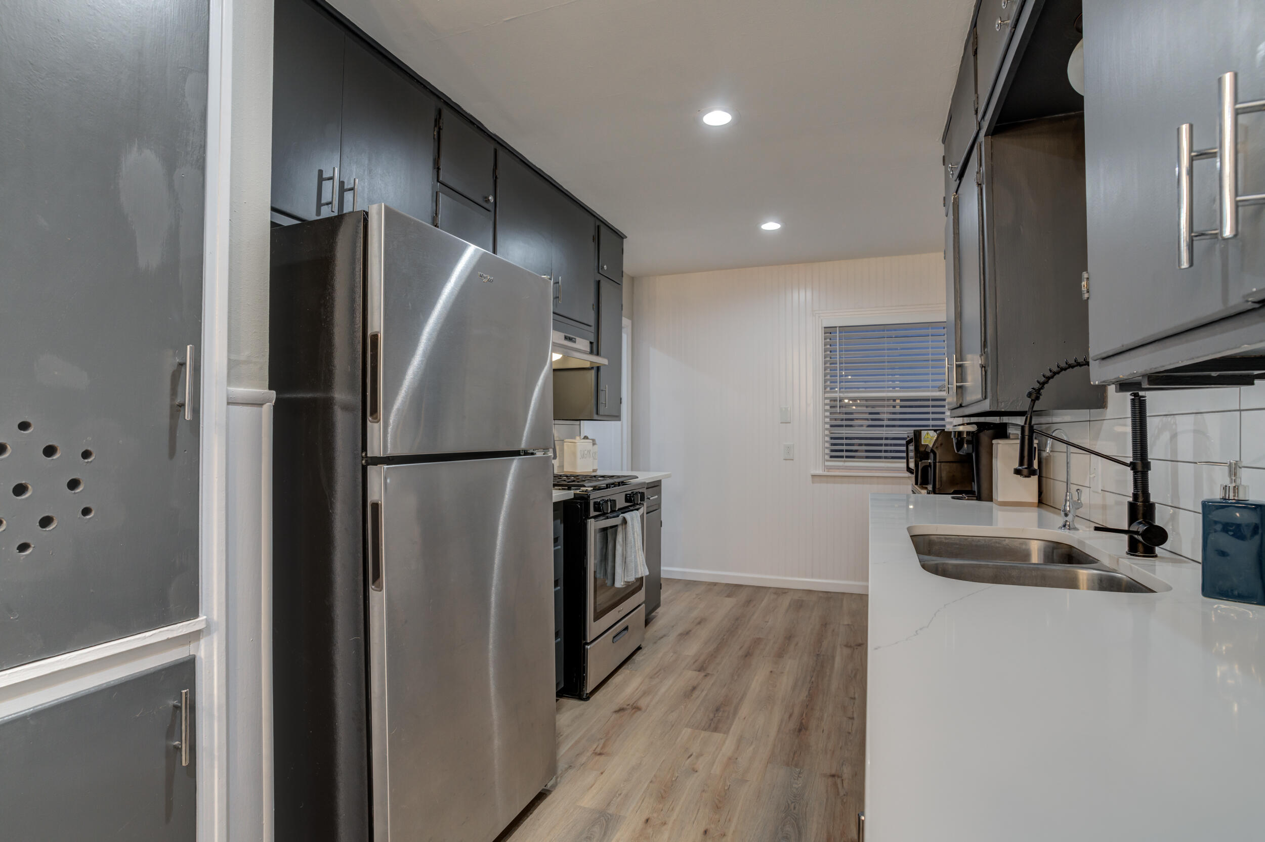 2802 39th Street Lubbock, TX 79413 - Photo 23 of 61 a kitchen with stainless steel appliances a refrigerator and a sink