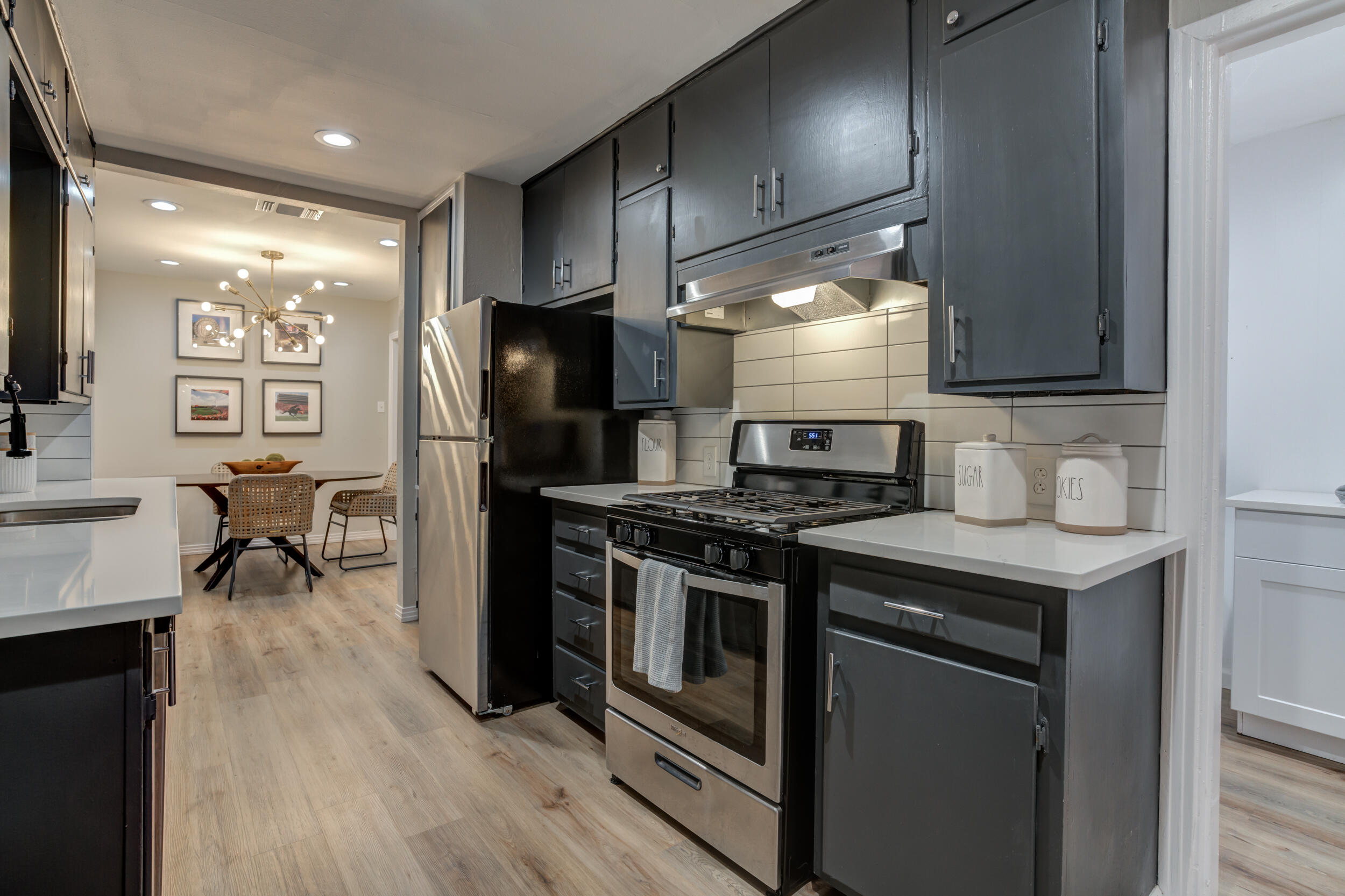 2802 39th Street Lubbock, TX 79413 - Photo 25 of 61 a kitchen with stainless steel appliances granite countertop a stove a refrigerator and a sink