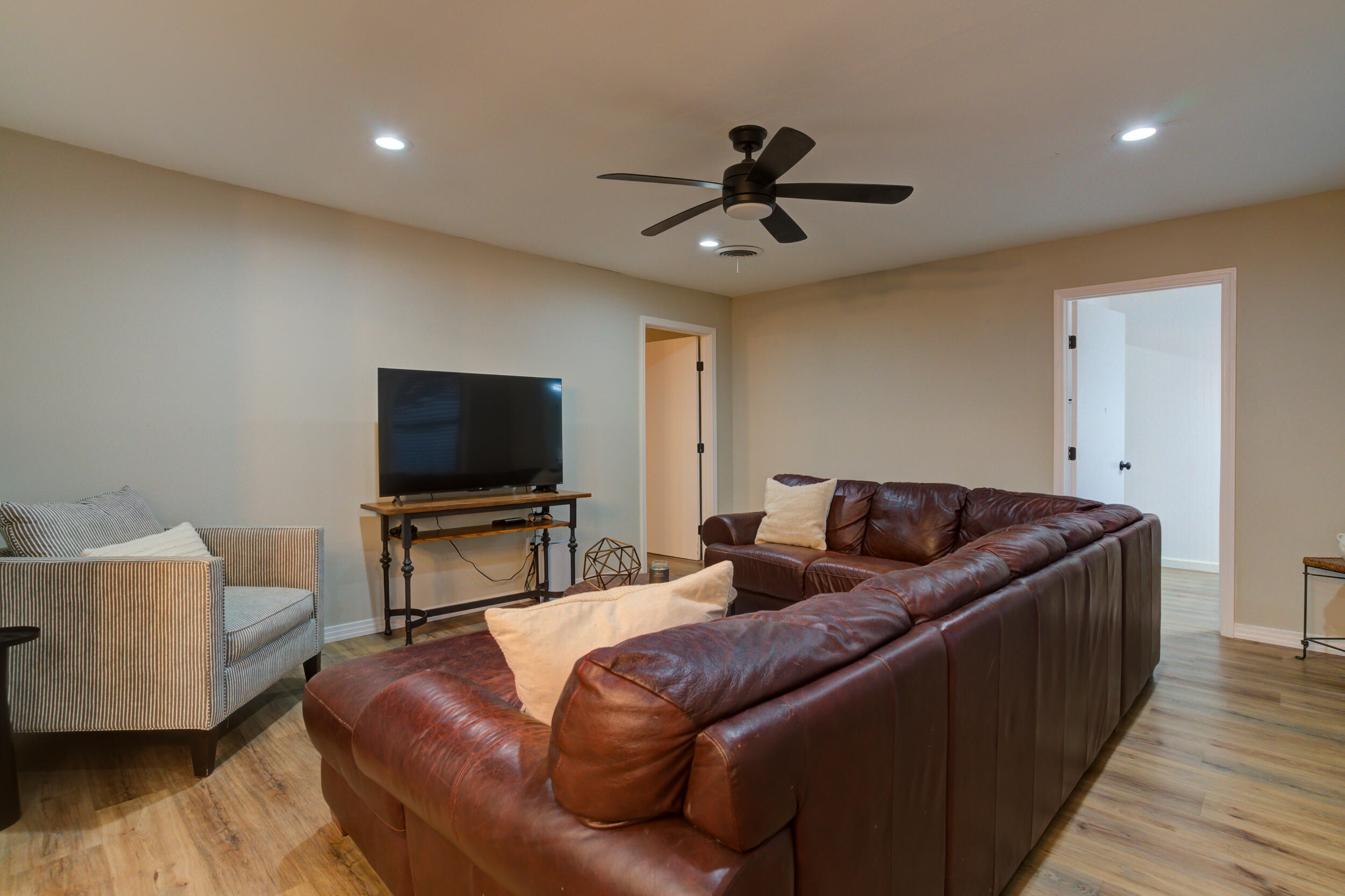 2802 39th Street Lubbock, TX 79413 - Photo 27 of 61 a living room with furniture and a flat screen tv