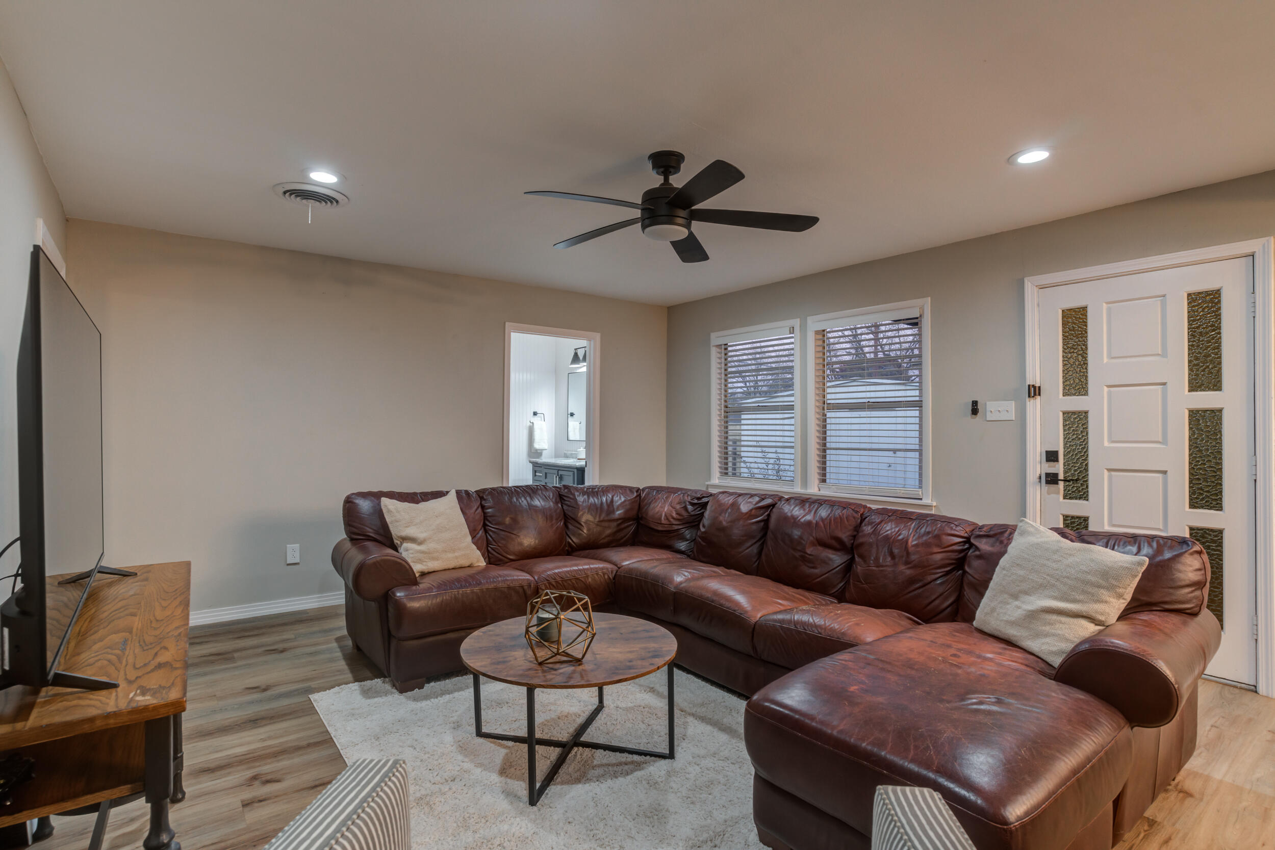 2802 39th Street Lubbock, TX 79413 - Photo 30 of 61 a living room with furniture a ceiling fan and a window