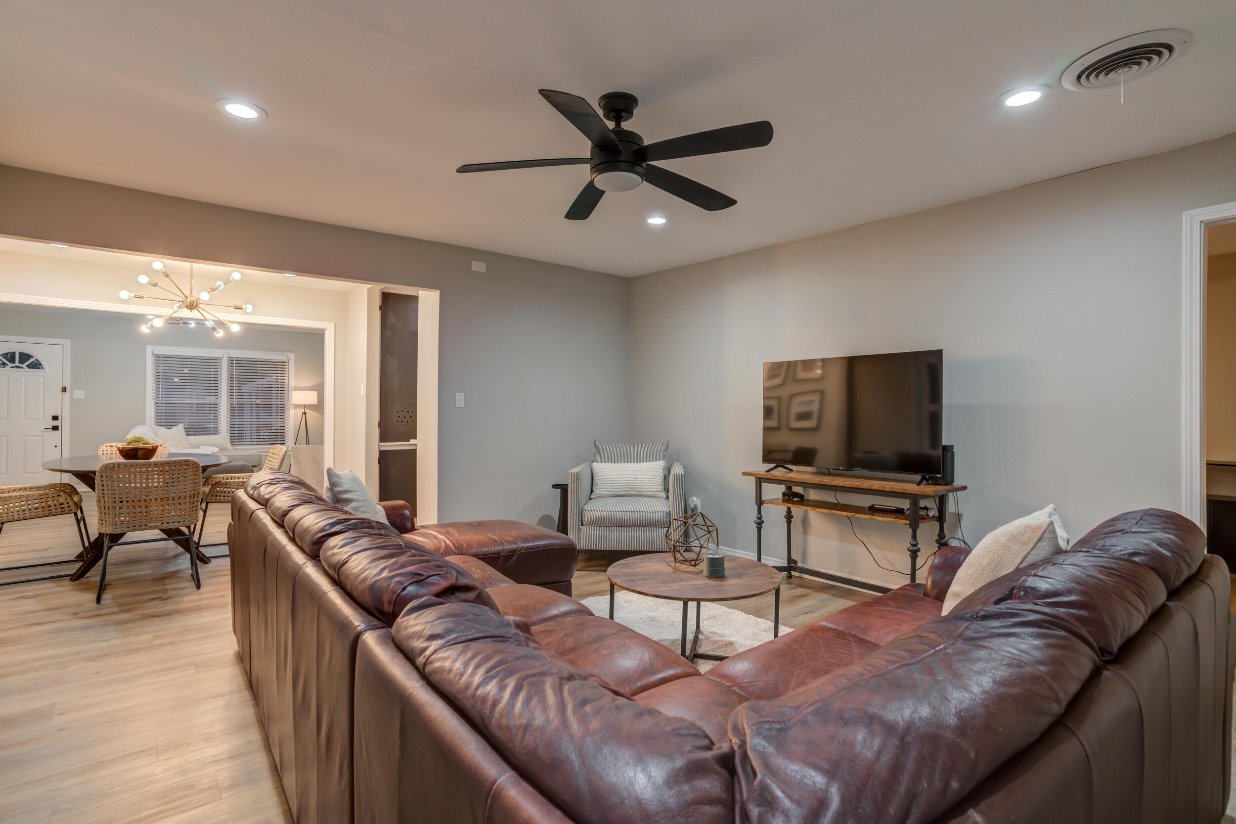 2802 39th Street Lubbock, TX 79413 - Photo 34 of 61 a living room with furniture and a flat screen tv with wooden floor