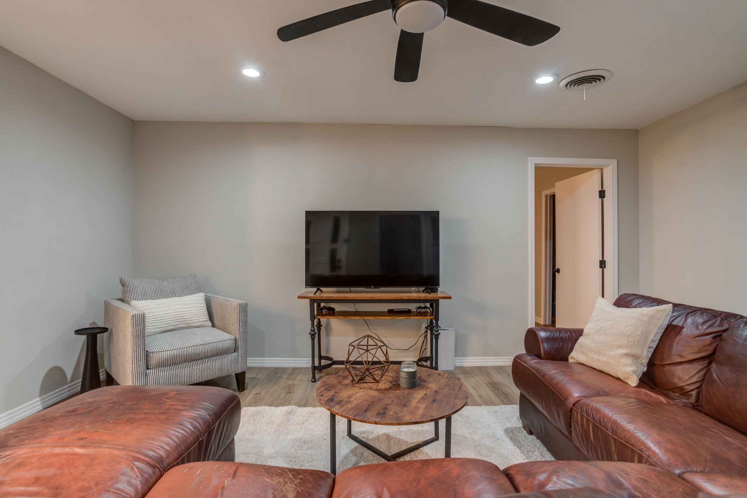 2802 39th Street Lubbock, TX 79413 - Photo 35 of 61 a living room with furniture and a flat screen tv