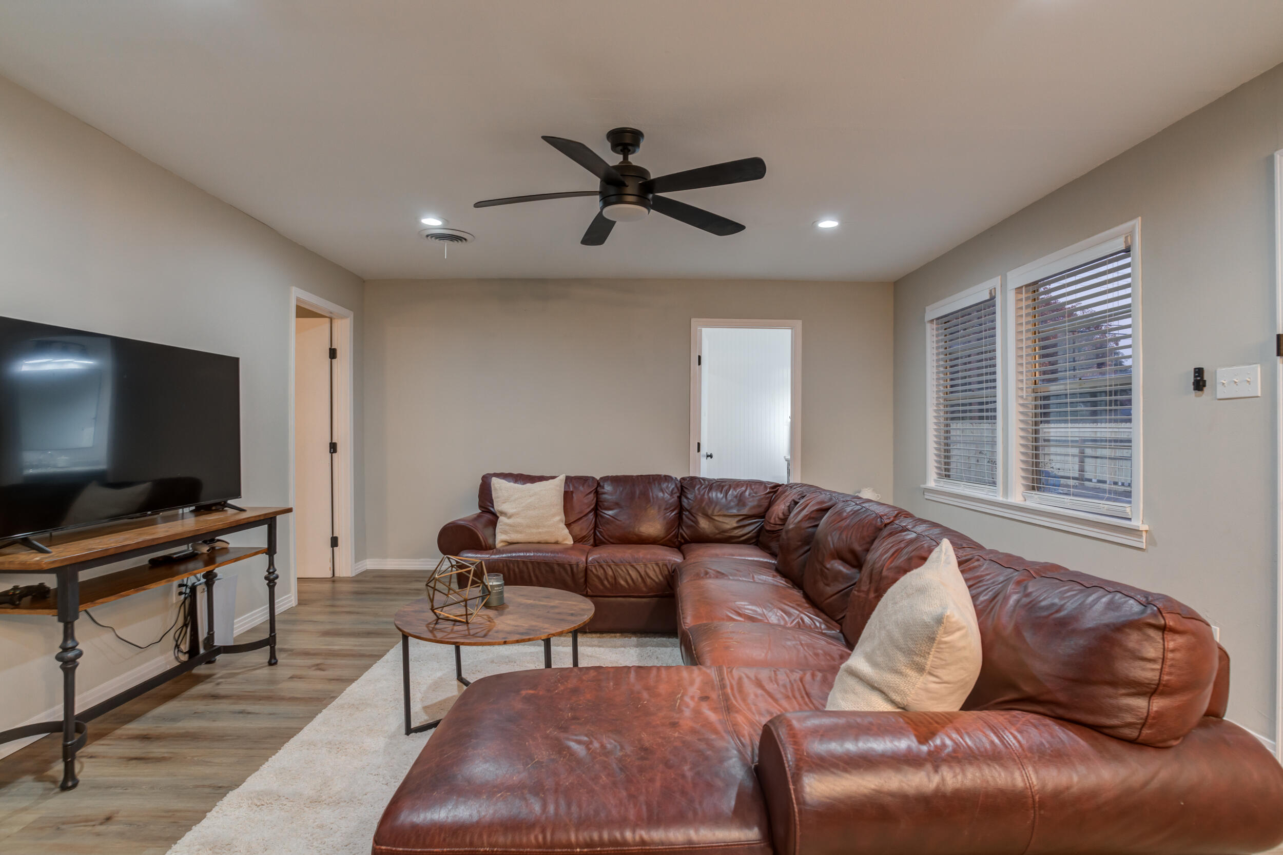2802 39th Street Lubbock, TX 79413 - Photo 36 of 61 a living room with furniture and a flat screen tv