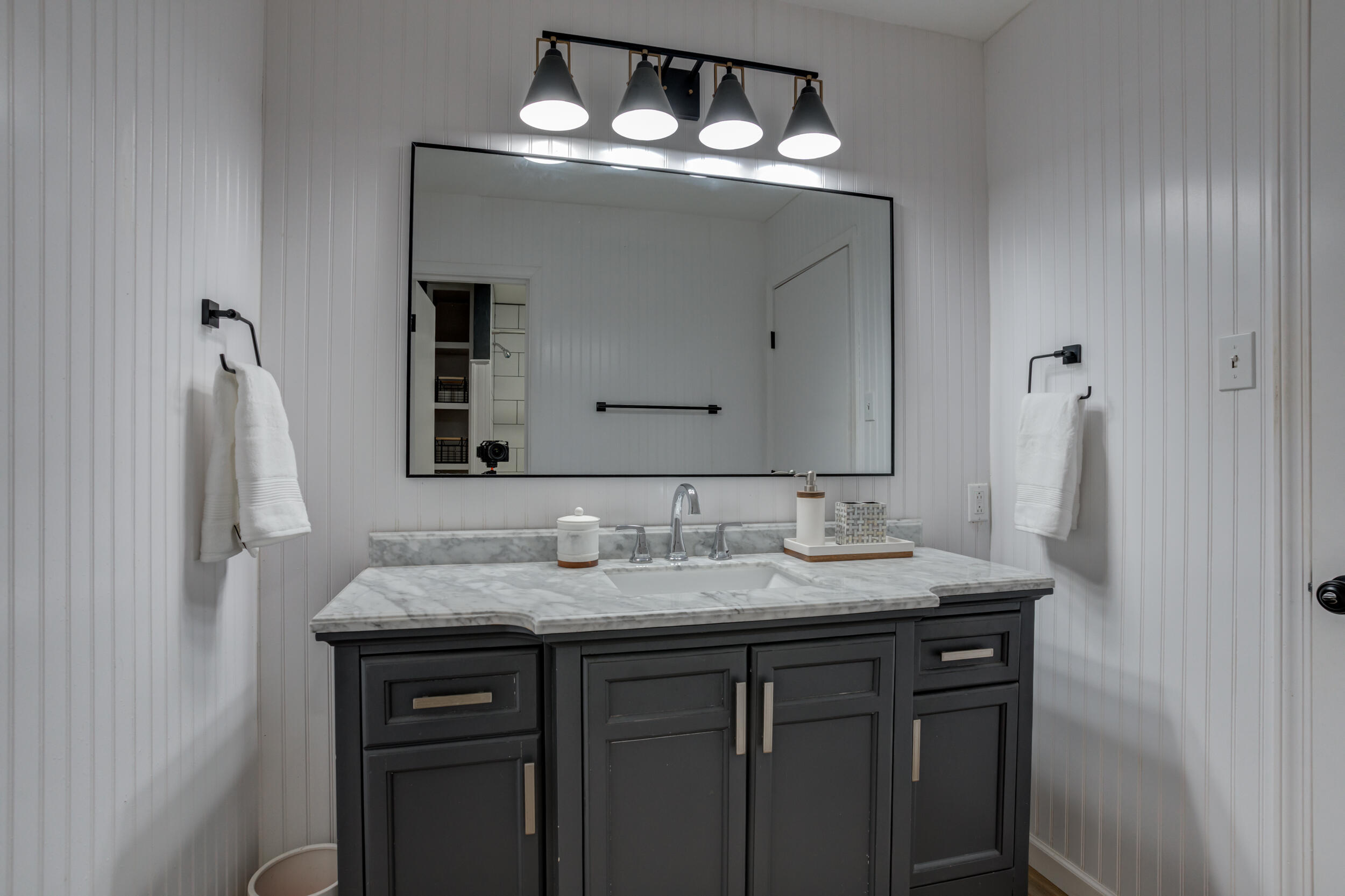 2802 39th Street Lubbock, TX 79413 - Photo 40 of 61 a bathroom with a sink and a mirror
