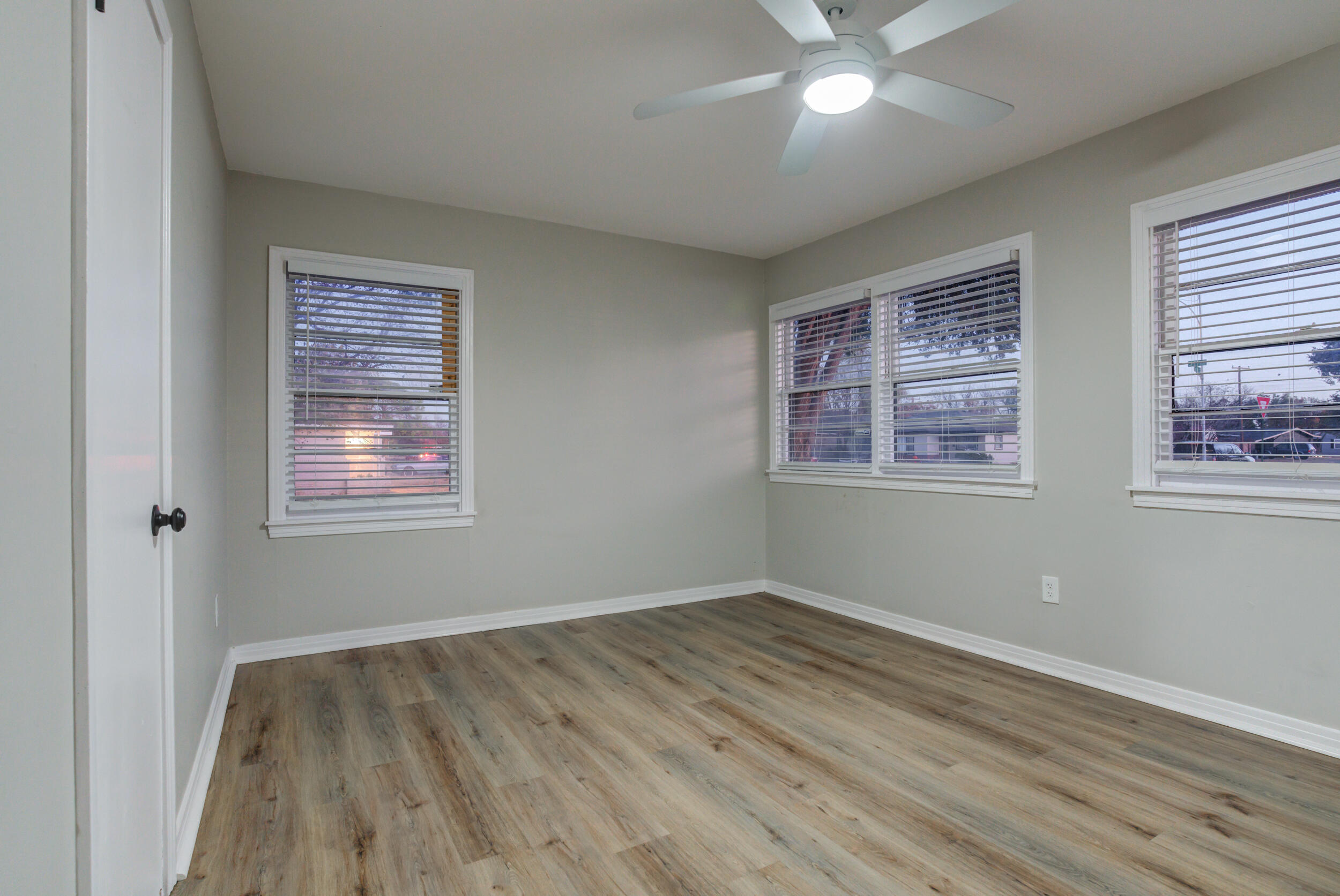 2802 39th Street Lubbock, TX 79413 - Photo 44 of 61 a view of an empty room with wooden floor and a window