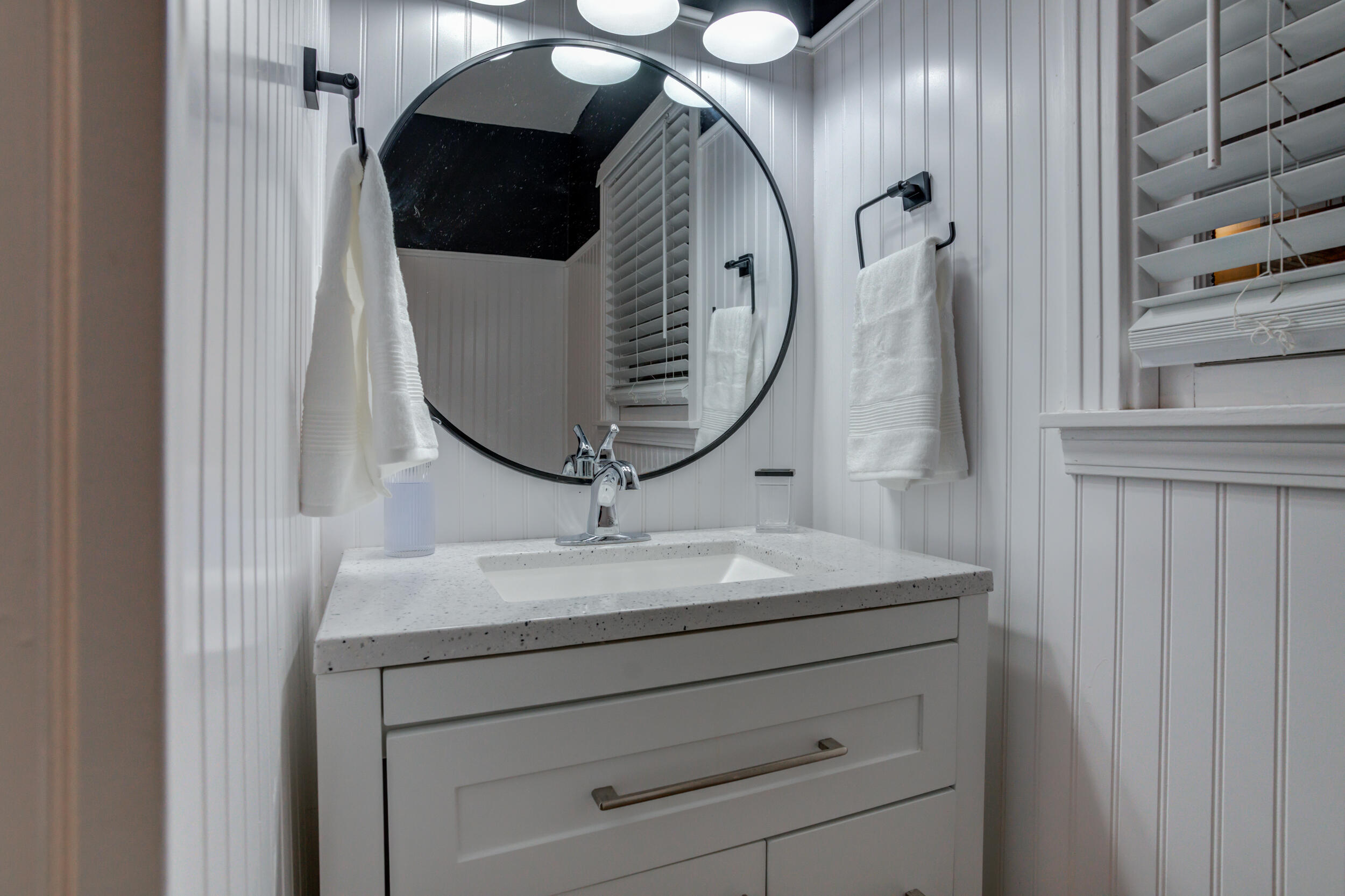 2802 39th Street Lubbock, TX 79413 - Photo 50 of 61 a bathroom with a sink and mirror