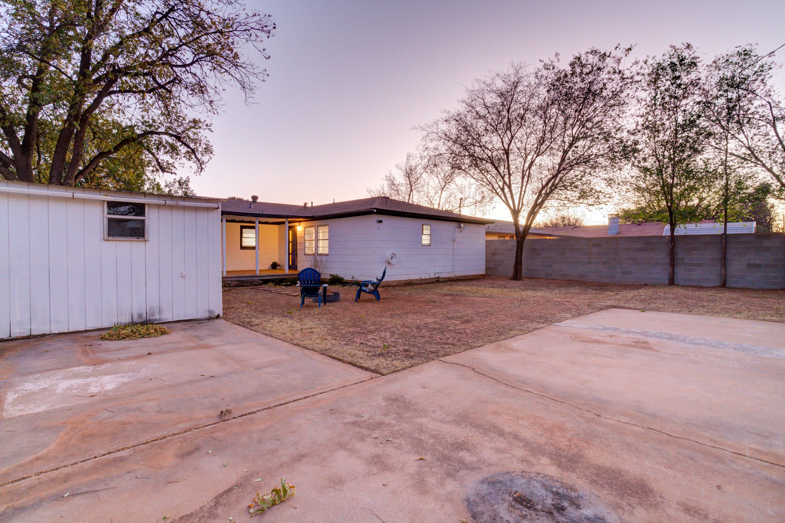 2802 39th Street Lubbock, TX 79413 - Photo 59 of 61 a backyard of a house with wooden fence and large trees