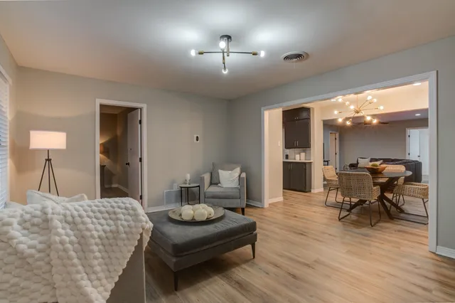 a dining room with furniture and wooden floor