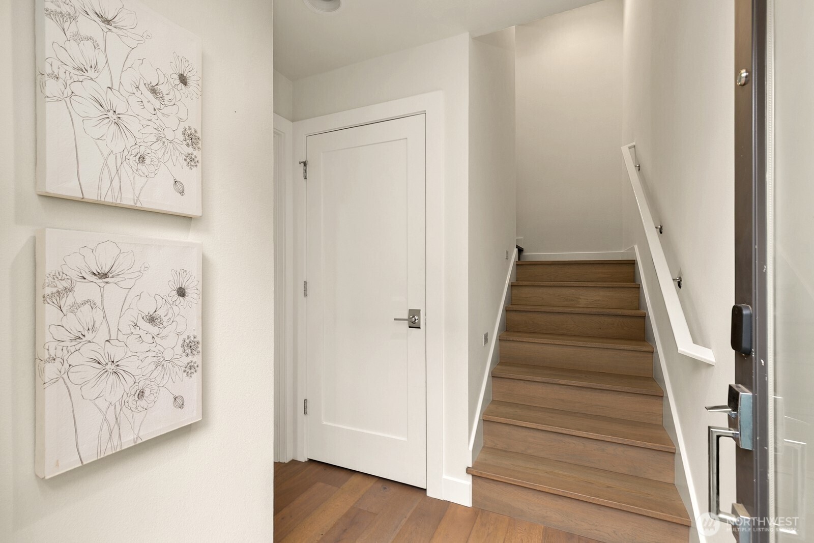 119 A 18th Avenue East Seattle, WA 98112 - Photo 15 of 24 a view of a hallway with wooden floor and front door