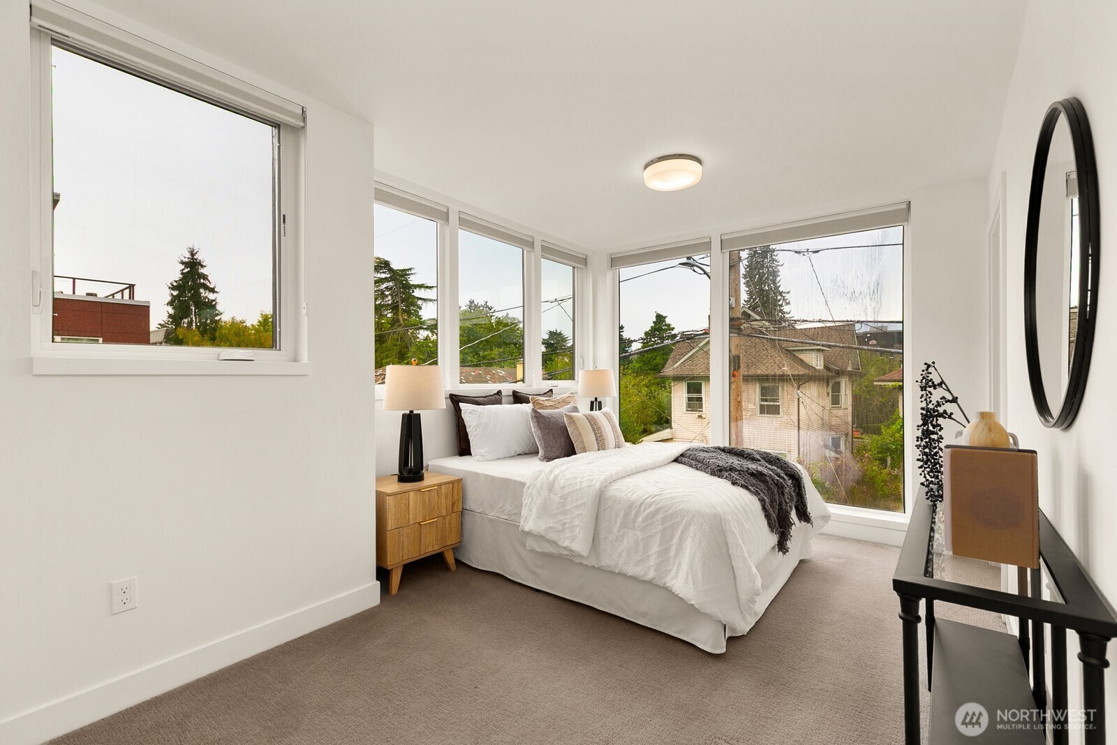 119 A 18th Avenue East Seattle, WA 98112 - Photo 17 of 24 a bedroom with a bed a large window with table and chairs