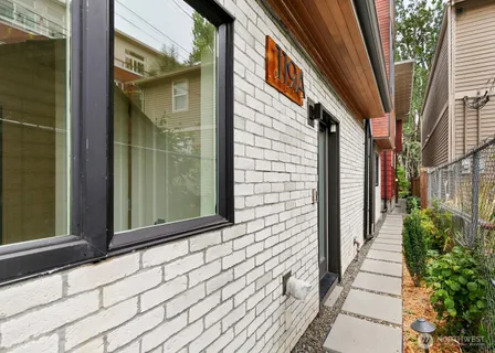 a view of a pathway both side of house