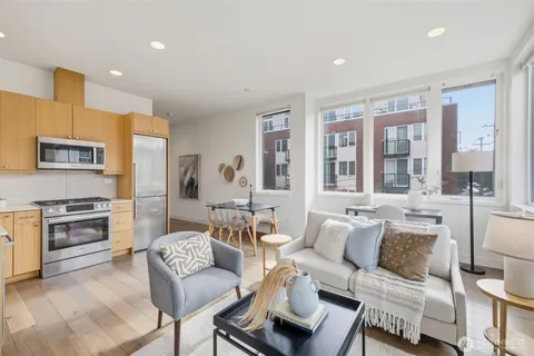 a living room with furniture and a kitchen