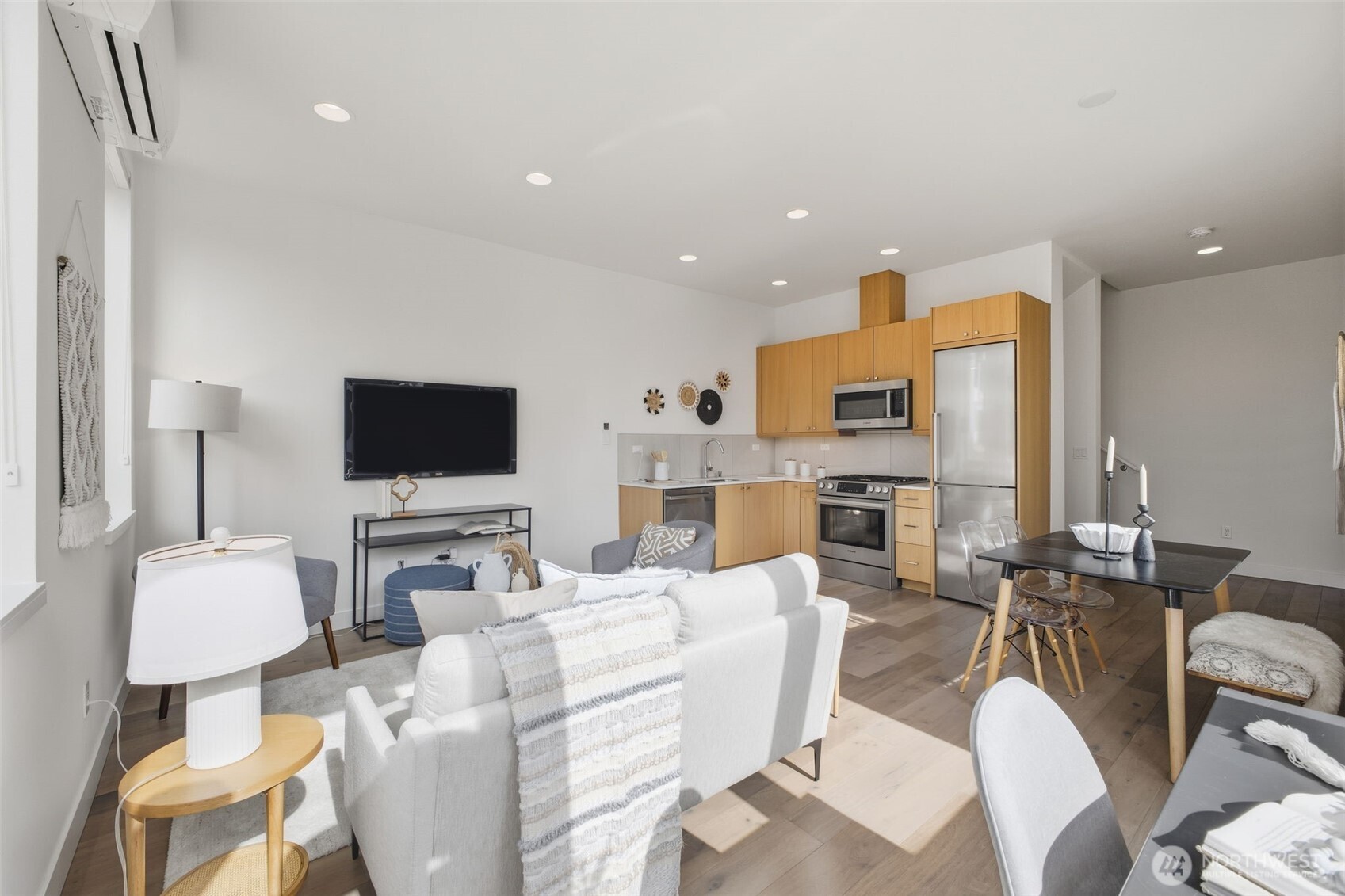 119 A 18th Avenue East Seattle, WA 98112 - Photo 4 of 24 a living room with furniture a flat screen tv and a view of kitchen