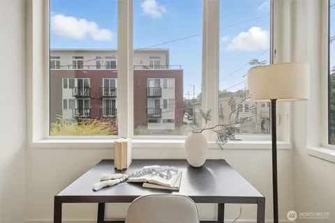 a view of a dining room with furniture and chandelier