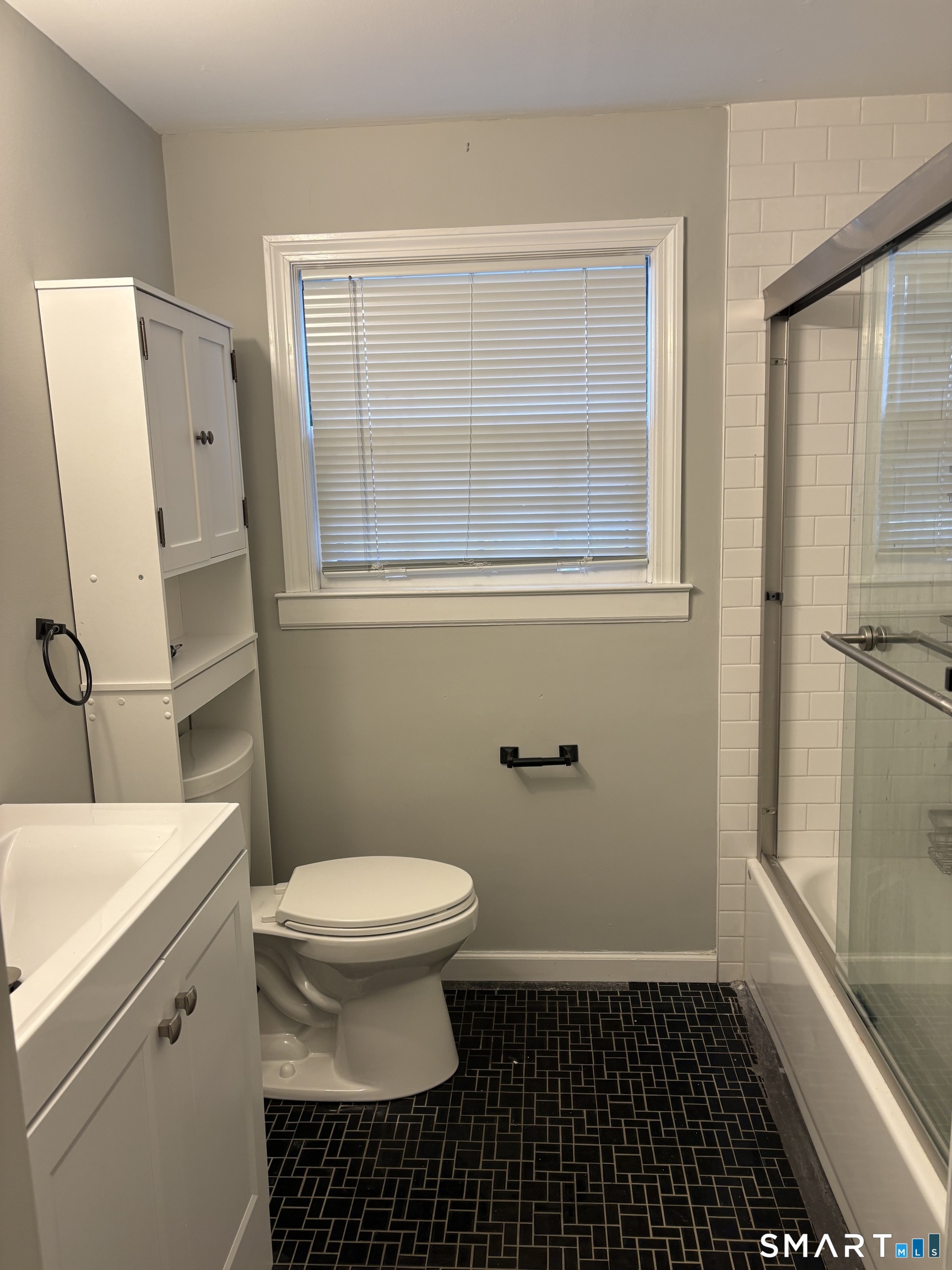 832 Milford Point Road Milford, CT 06460 - Photo 11 of 11 a bathroom with a sink a toilet a shower a window and vanity