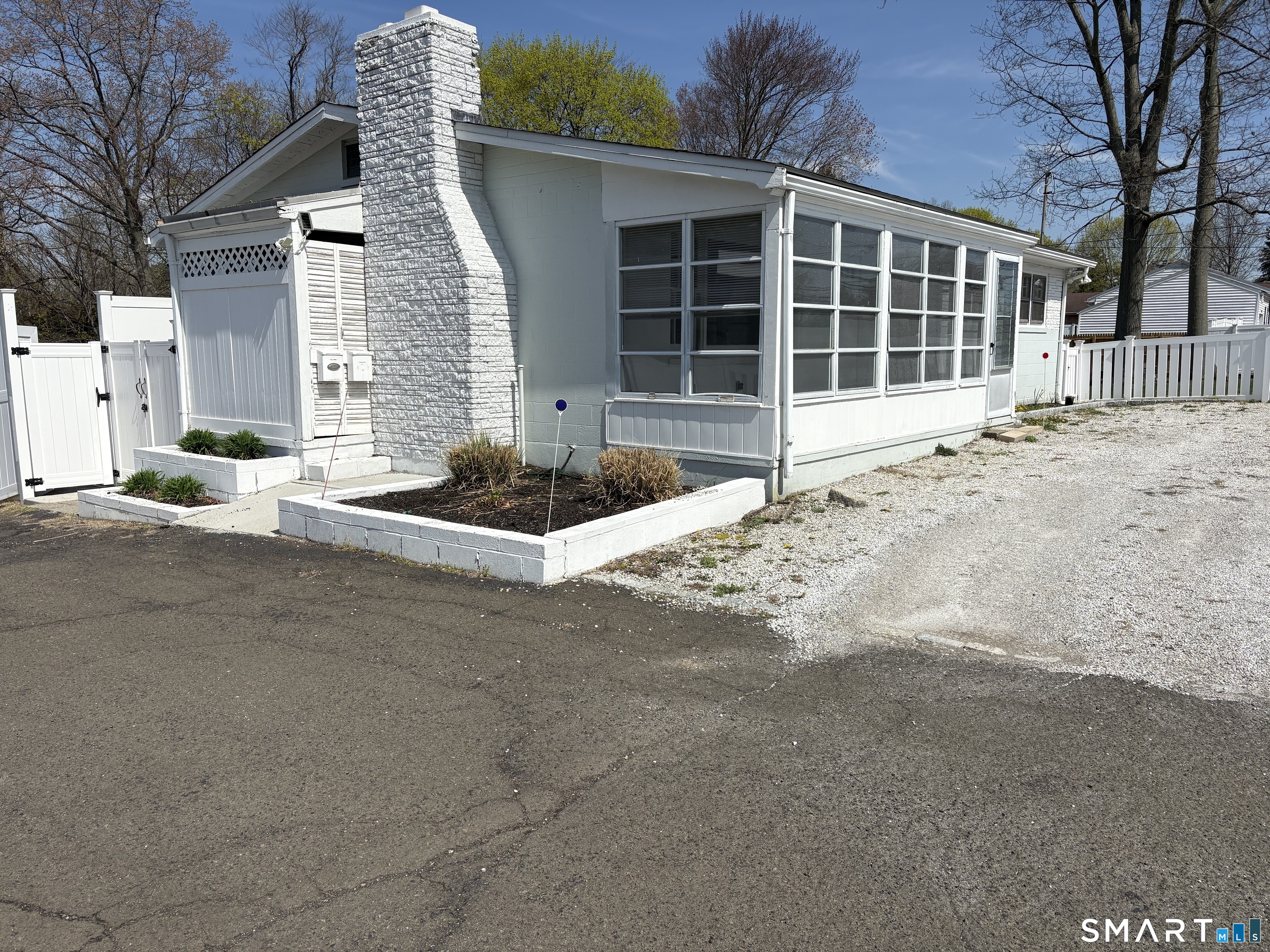 832 Milford Point Road Milford, CT 06460 - Photo 2 of 11 a front view of a house with a yard and garage