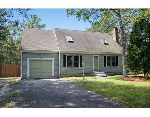 215 Simons Road Mashpee, MA 02649 - Photo 1 of 19 a backyard of a house with yard table and chairs