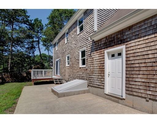 215 Simons Road Mashpee, MA 02649 - Photo 18 of 19 a back view of a house with a backyard