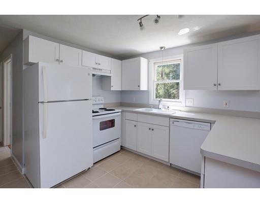 215 Simons Road Mashpee, MA 02649 - Photo 7 of 19 a kitchen with white cabinets and white appliances